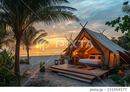 Beachside glamping experience tropical paradise accommodation sunset outdoor relaxation 131054577