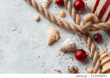 Rope, shells and Christmas decor on white grunge background. Top view Rope, shells and Christmas decor on white grunge background. Top view 131056851