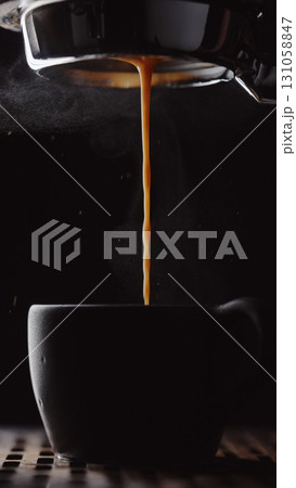shot pull espresso shot with bottomless portafilter on a professional coffee machine 131058847
