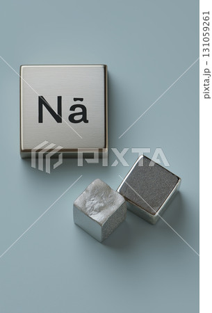 Metallic blocks with symbol for sodium on light blue background, showcasing modern and minimalistic design with scientific theme Metallic blocks with symbol for sodium on light blue background, showcasing modern and minimalistic design with scientific theme 131059261