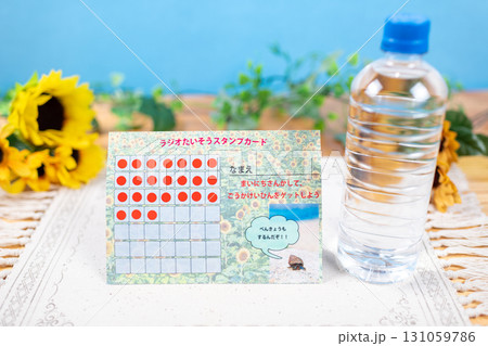 夏休みのラジオ体操用のスタンプカードと水 夏休みのラジオ体操用のスタンプカードと水 131059786