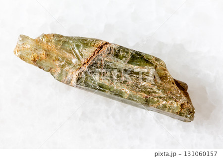sample of rough epidote crystal on white marble sample of rough epidote crystal on white marble 131060157