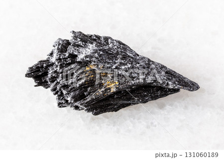 sample of raw black kyanite mineral on white 131060189