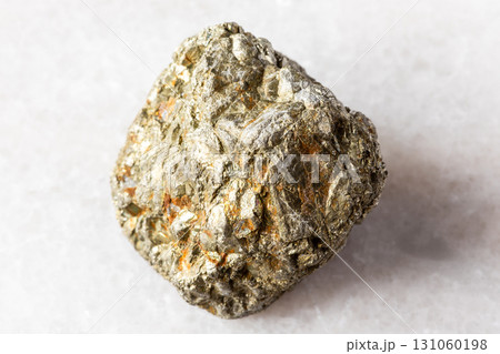 sample of rough pyrite rock on white marble 131060198