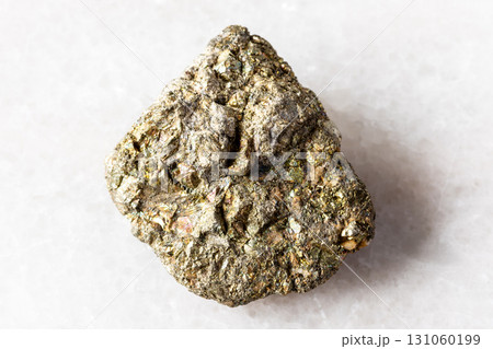 sample of uncut pyrite mineral on white marble sample of uncut pyrite mineral on white marble 131060199