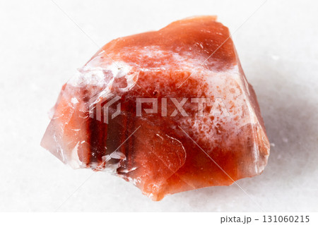 raw carneol chalcedony mineral on white marble 131060215