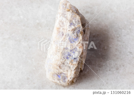raw belomorite moonstone mineral on white marble 131060216