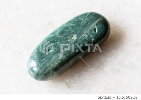 polished trass chernomorite mineral on white 131060218