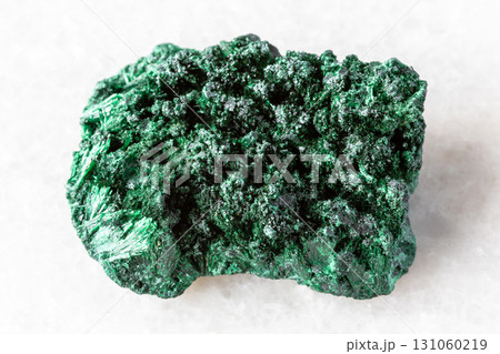 raw fibrous malachite mineral on white marble raw fibrous malachite mineral on white marble 131060219