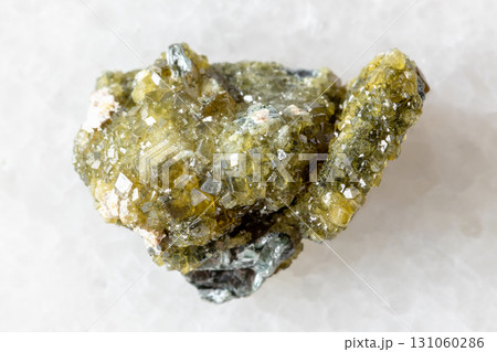 raw druse of topazolite andradite mineral on white 131060286