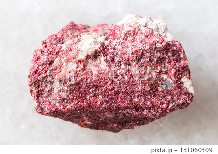 sample of raw cinnabar mineral on white marble 131060309