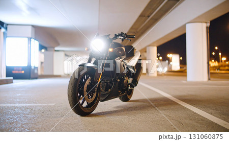 Sleek Motorcycle Parked Under Urban Overpass at Night Sleek Motorcycle Parked Under Urban Overpass at Night 131060875