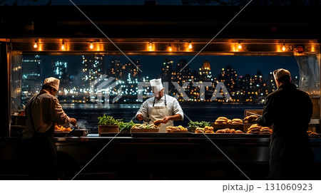 Chefs preparing food at outdoor kitchen at night Chefs preparing food at outdoor kitchen at night 131060923