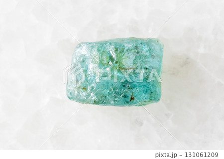 rough starlite blue zircon mineral on white marble 131061209