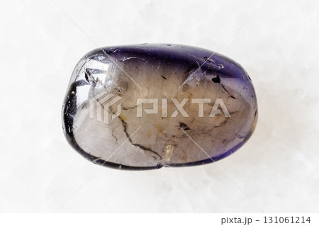 sample of polished iolite mineral on white marble 131061214