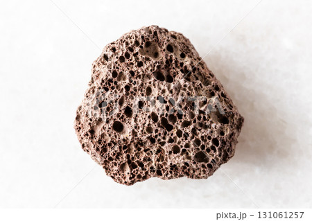 sample of rough brown pumice mineral on white 131061257