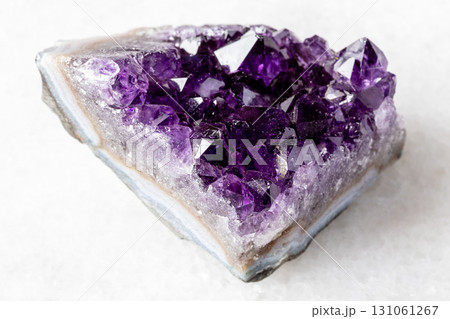 rough geode of amethyst mineral crystals on white rough geode of amethyst mineral crystals on white 131061267