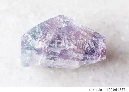 sample of rough purple fluorite mineral on white 131061271