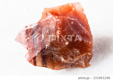raw carneol chalcedony rock on white marble 131061290