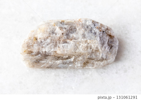 raw belomorite moonstone rock on white marble 131061291