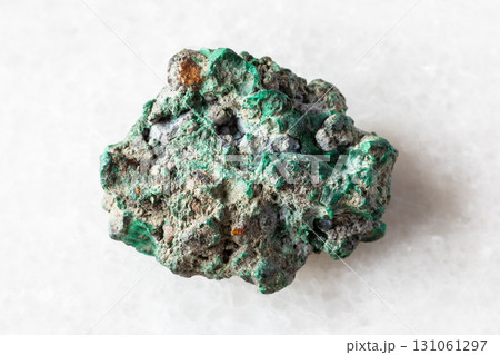 sample of raw malachite rock on white marble 131061297