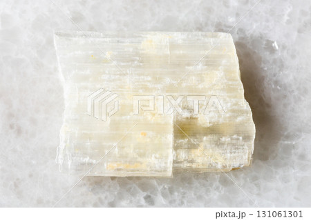 sample of raw eudidymite mineral on white marble 131061301