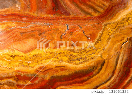polished surface of banded cave onyx rock close up 131061322