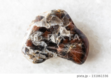 sample of polished monzonite mineral on white 131061336