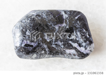 sample of polished stibnite mineral on white 131061338