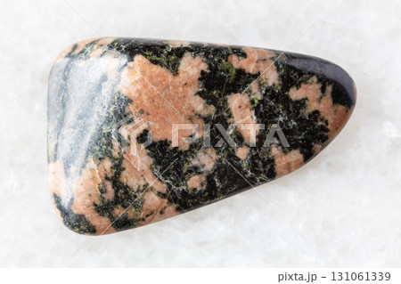 sample of polished gabbro rock on white marble 131061339