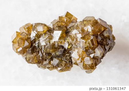 rough druse of andradite garnet crystals on white 131061347