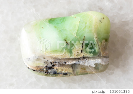 sample of polished green opalite mineral on white 131061356