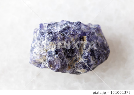sample of raw cordierite mineral on white marble 131061375