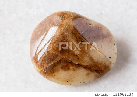 sample of tumbled brown quartzite rock on white 131062134