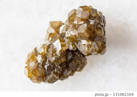 raw druse of andradite garnet crystals on white 131062169