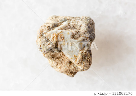 sample of raw achtarandite mineral on white marble 131062176