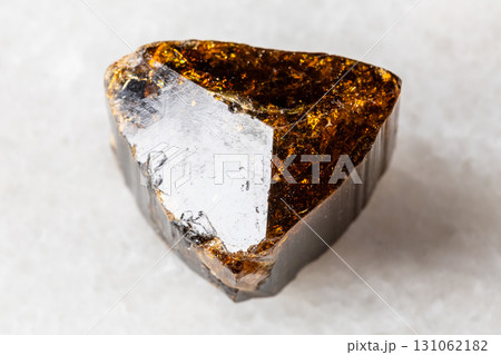 sample of raw dravite tourmaline mineral on white 131062182