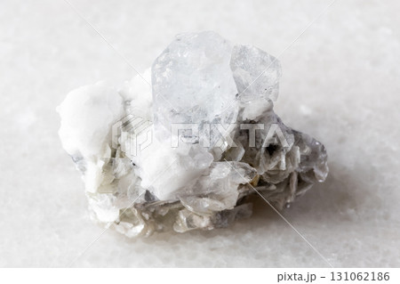colorless beryl with mica, feldspar rock on white 131062186