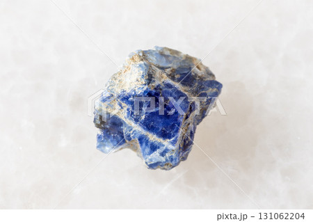 sample of raw benitoite crystal on white marble sample of raw benitoite crystal on white marble 131062204