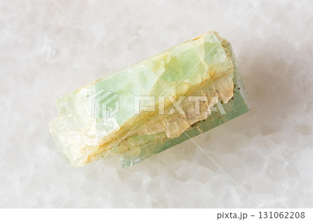 sample of raw green beryl crystal on white marble sample of raw green beryl crystal on white marble 131062208
