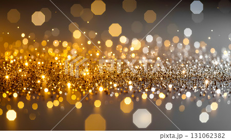 A bright and sparkling abstraction with a scattering of gold and silver glitter. The image resembles stardust or a magical trail left by light. Perfect for creating a festive mood for Christmas, New Y 131062382