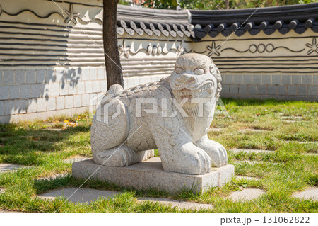 Korean Haechi statue at the entrance to Korea Garden Park. Stone guardian lion. Traditional Oriental Asian architecture. Korean Haechi statue at the entrance to Korea Garden Park. Stone guardian lion. Traditional Oriental Asian architecture. 131062822