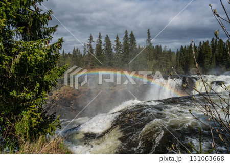Ristafallet Waterfall in Sweden with a rainbow in the sky. Ristafallet Waterfall in Sweden with a rainbow in the sky. 131063668