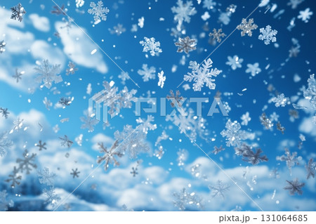 snowfall on a bright day against the sky and a snow-covered plain as a background, a close view of snowflakes 131064685