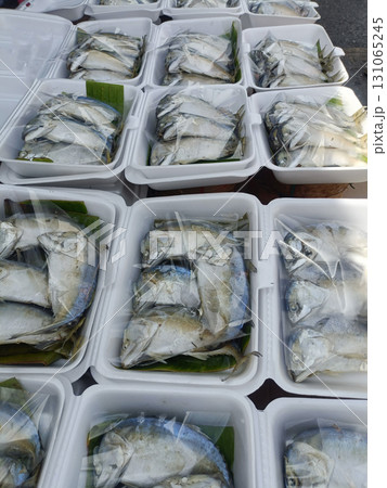 Fresh fish packaged in white foam containers with plastic wrapping, ready for sale or distribution, likely at market or seafood stall Fresh fish packaged in white foam containers with plastic wrapping, ready for sale or distribution, likely at market or seafood stall 131065245