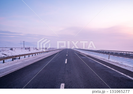 Empty Highway in Winter Landscape at Sunset or Sunrise 131065277