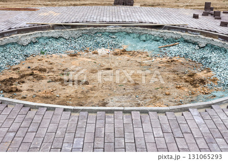Round Construction Pit on Sidewalk in Newly Developing Park, Showcasing Urban Development and Infrastructure Improvements for Community Spaces 131065293