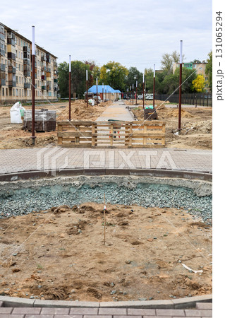 Construction of a New Urban Park: Leveling the Ground and Laying New Sidewalks for a Vibrant Community Space 131065294