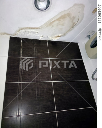 Bathroom damage reveals concerning leak, leaving homeowner frustrated with unsightly peeling paint 131065407