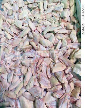 Chicken wing displayed fills frame, ready to be cooked 131065408